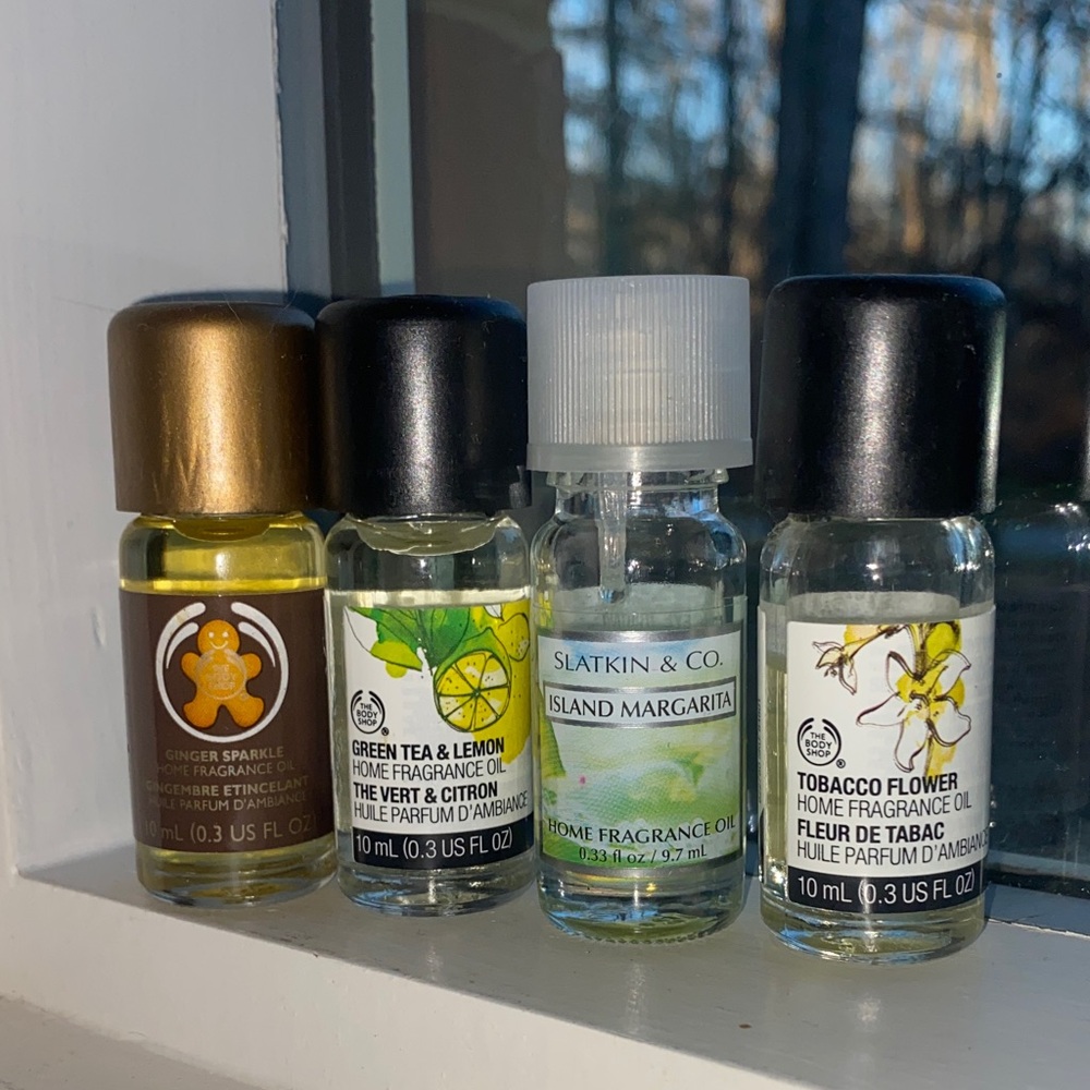 Lot of 4 home fragrance oils from The Body Shop and Slatkin & Co